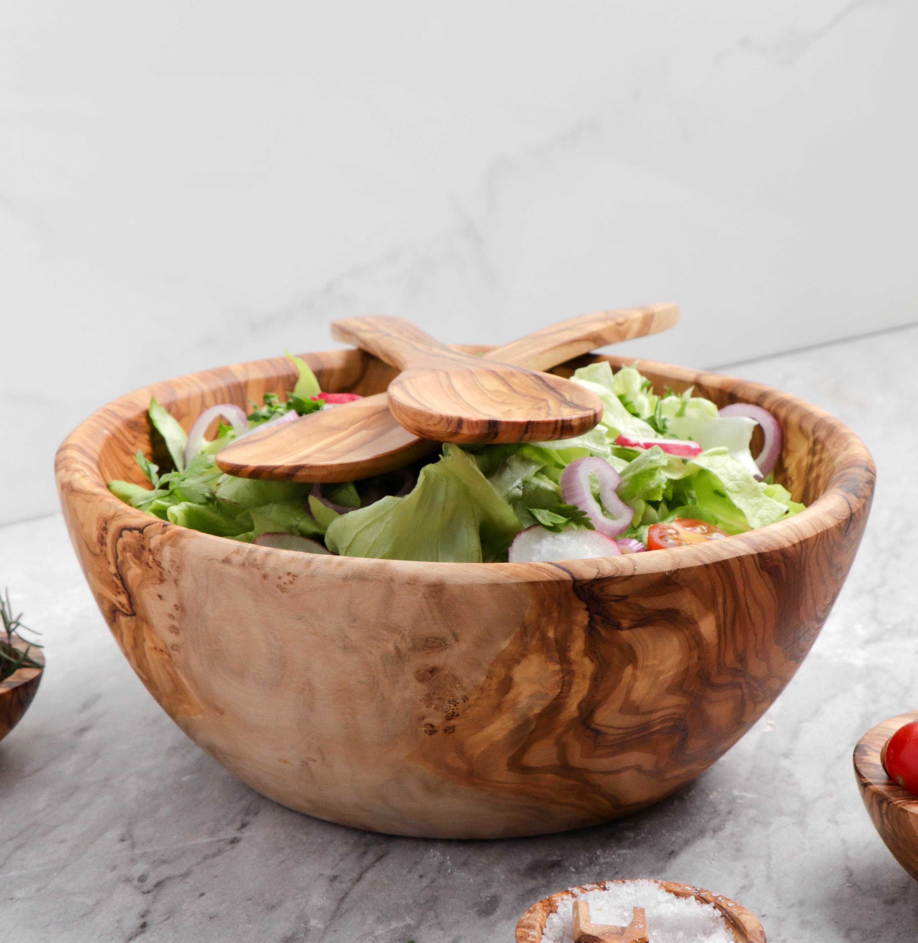 Artisan-crafted Large Olive Wood Bowl, with its rich, natural patterns, stands out as a multifunctional piece for salads, fruits, or as an elegant home décor item, enhancing your kitchen's aesthetic.